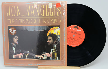 Vinyl record with cover featuring 'Jon Vangelis and The Friends of Mr. Cairo' on a white background