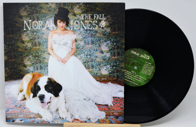 Norah Jones 'The Fall' vinyl record LP with its album cover in front of the black record, photographed on a light gray background.