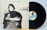 Joni Mitchell 'Hejra' vinyl record LP with the album cover standing next to the black record on a small wooden stand against a light gray background.