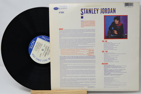Vinyl record with cover featuring Stanley Jordan on a white background