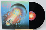Vinyl record with a colorful cover featuring abstract designs.
