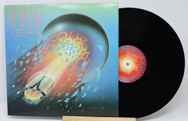 Vinyl record with a colorful cover featuring abstract designs.