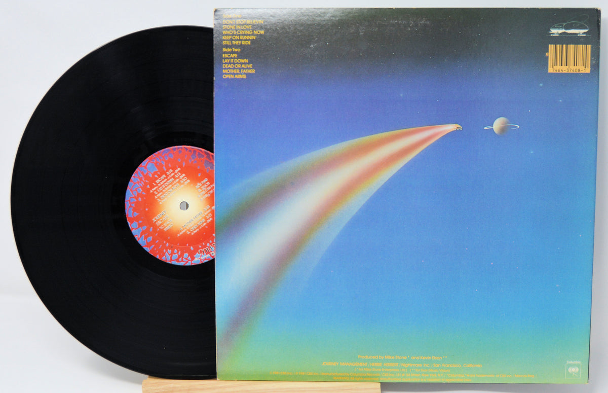 Vinyl record with a colorful cover featuring a rainbow and celestial design.