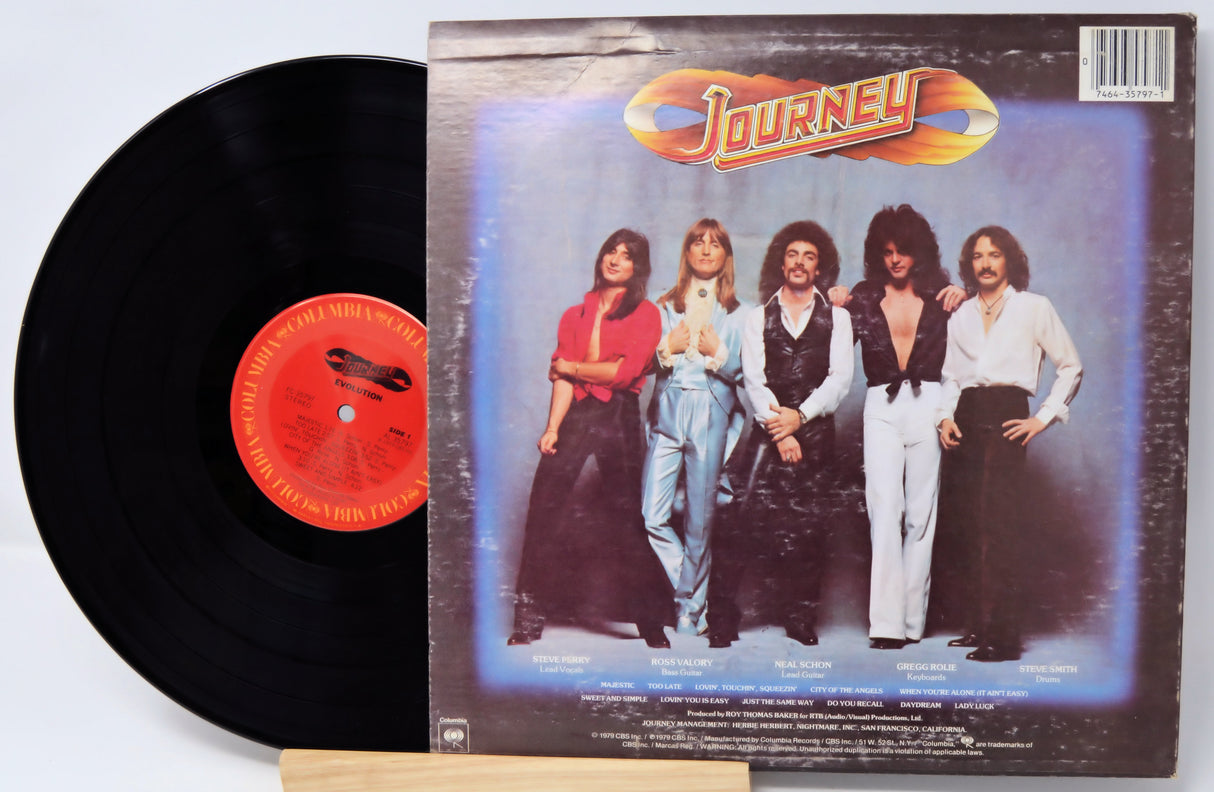 Vinyl record with 'Journey' album cover featuring band members.
