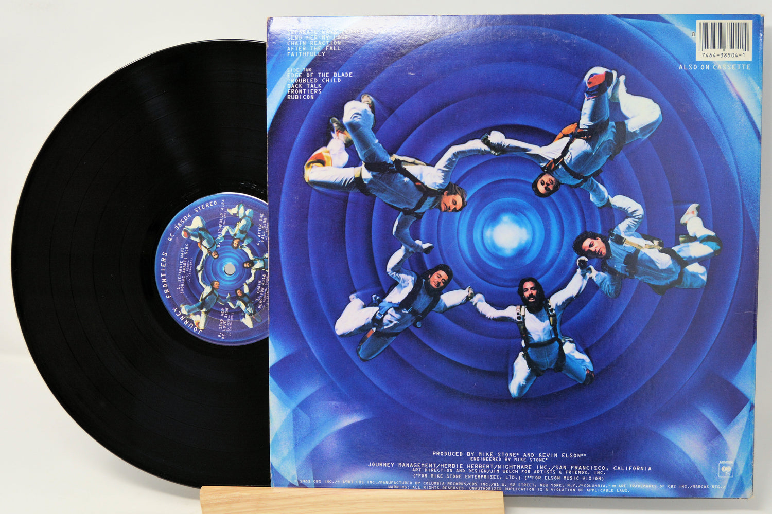 Vinyl record with a blue and white cover featuring a spiral design and people in space suits.