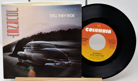 Vinyl record and cover with 'Columbia' label and car illustration on a white background