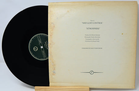 Vinyl record with a textured cover on a light gray background
