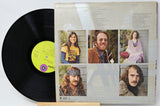 Vinyl record with a colorful cover featuring portraits of people