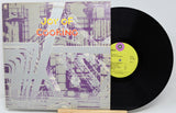 Vinyl record with a colorful cover titled 'Joy of Cooking' on a white background