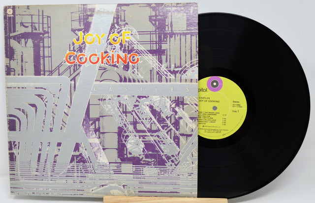 Vinyl record with a colorful cover titled 'Joy of Cooking' on a white background