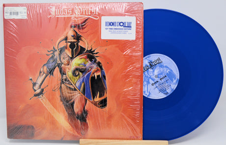 Vinyl record with blue disc and colorful cover featuring a horse and abstract design.