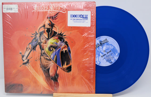Vinyl record with blue disc and colorful cover featuring a horse and abstract design.