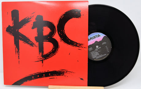 Vinyl record with a red cover featuring 'KBC' and a black record on a white background