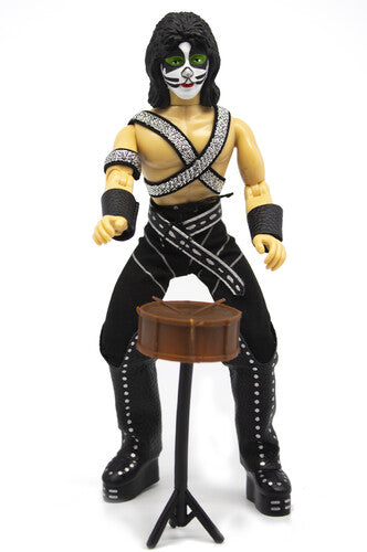 Action figure with black and white makeup, black pants, and yellow top on a white background
