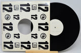Vinyl record with a cover featuring the number 12 on a white background