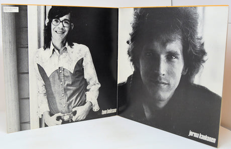 Vinyl record with cover featuring pixelated artwork of three faces on a blue background