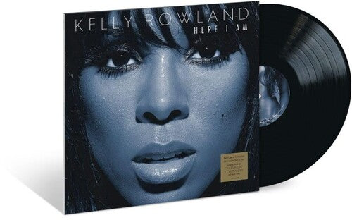 Kelly Rowland's 'Here I Am' vinyl record album, showing the black LP partially pulled from the sleeve against a white background.