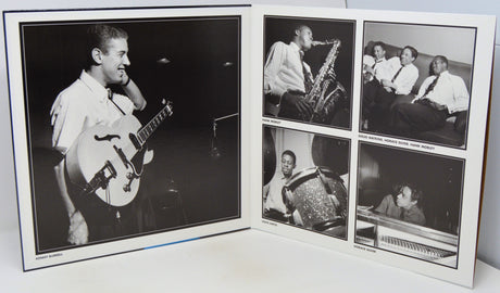 An open printed album or photo book showing black-and-white photographs of a musician performing, photographed on a white surface against a white background.