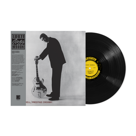 Vinyl record with a yellow label and a black and white album cover of a man playing guitar.