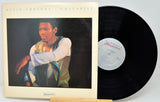 Vinyl record with cover featuring a guitarist on a white background