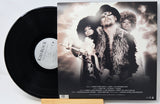A vinyl record partially pulled from its sleeve, showing the black record on the left and the printed album cover on the right. The cover features a sepia-toned portrait of three people, with the text 'KID ROCK' visible on the record label.