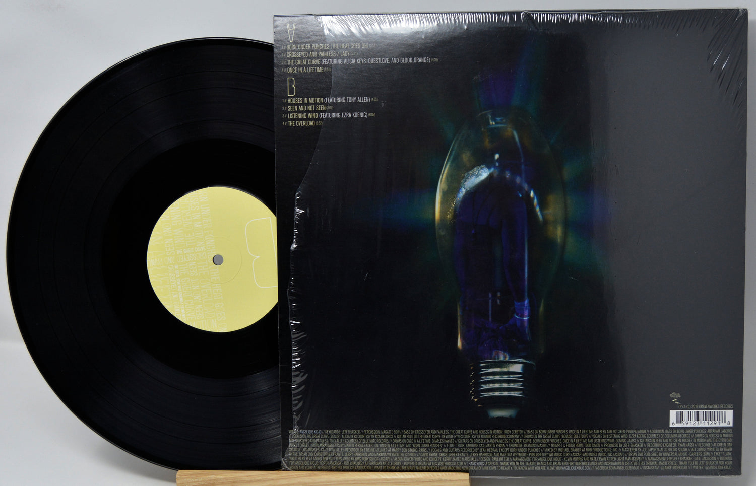 Vinyl record with a yellow label and its cover featuring an illustration of a light bulb.