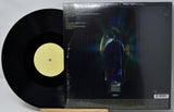 Vinyl record with a yellow label and its cover featuring an illustration of a light bulb.