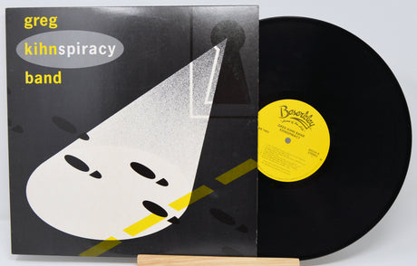 Vinyl record with a stylized front cover featuring abstract shapes and text titled Kihnspiracy by Greg Kihn Band.
