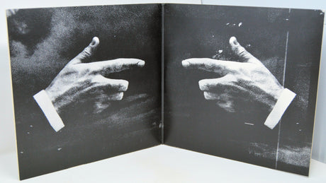 Black and white album gatefold artwork showing two hands in pointing gesture