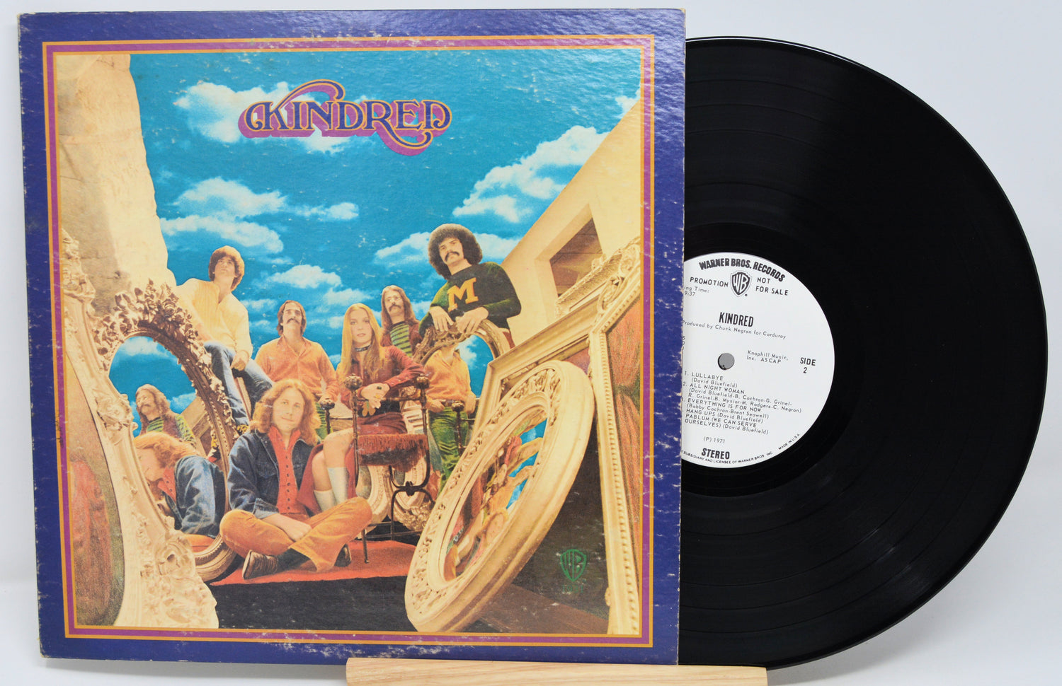 Vinyl record with a colorful cover featuring a group of people and musical instruments.