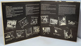 Open book with black and white film strip illustrations on a white background