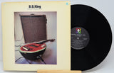 Vinyl record with a watermelon-shaped guitar on the cover and a visible label.