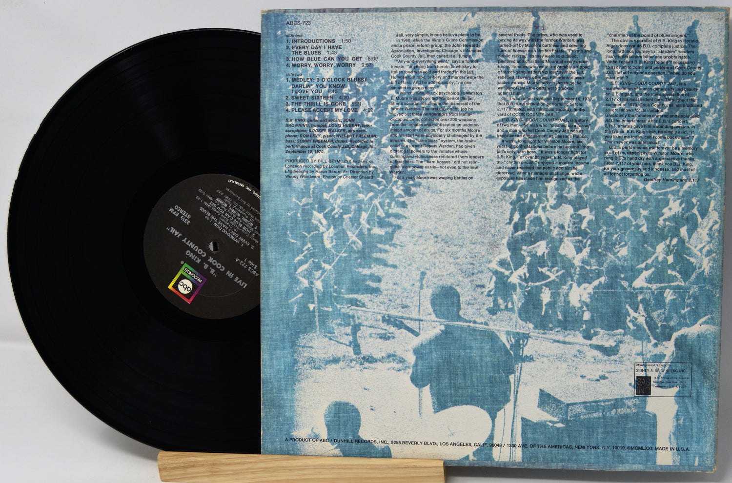 Vinyl record with a blue and white cover featuring artistic design and text.