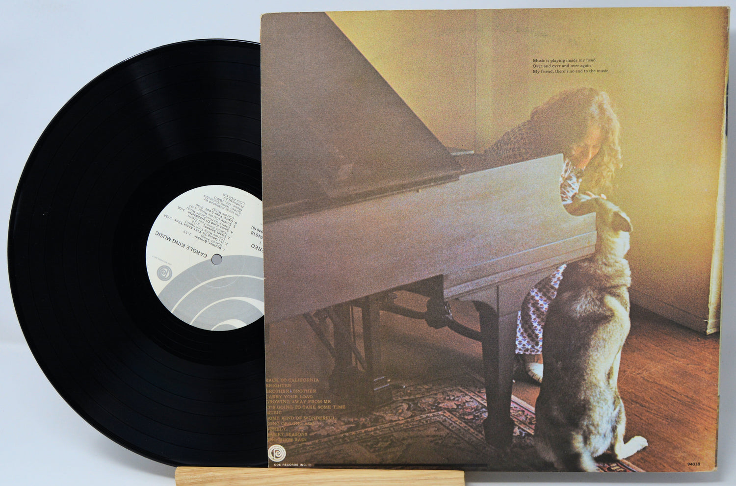 Vinyl record with a cover featuring a person and dog by a piano