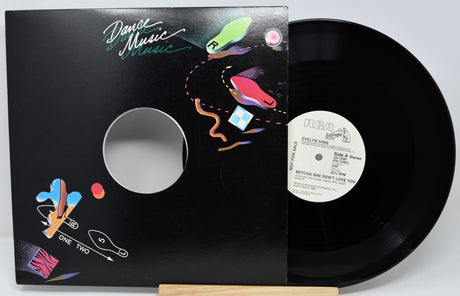 Vinyl record with colorful cover and visible label on a white background