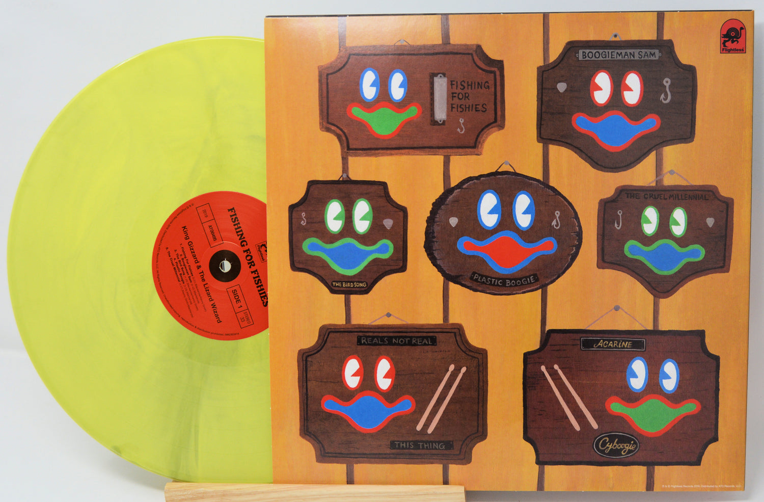 Vinyl record with a colorful face design on the cover