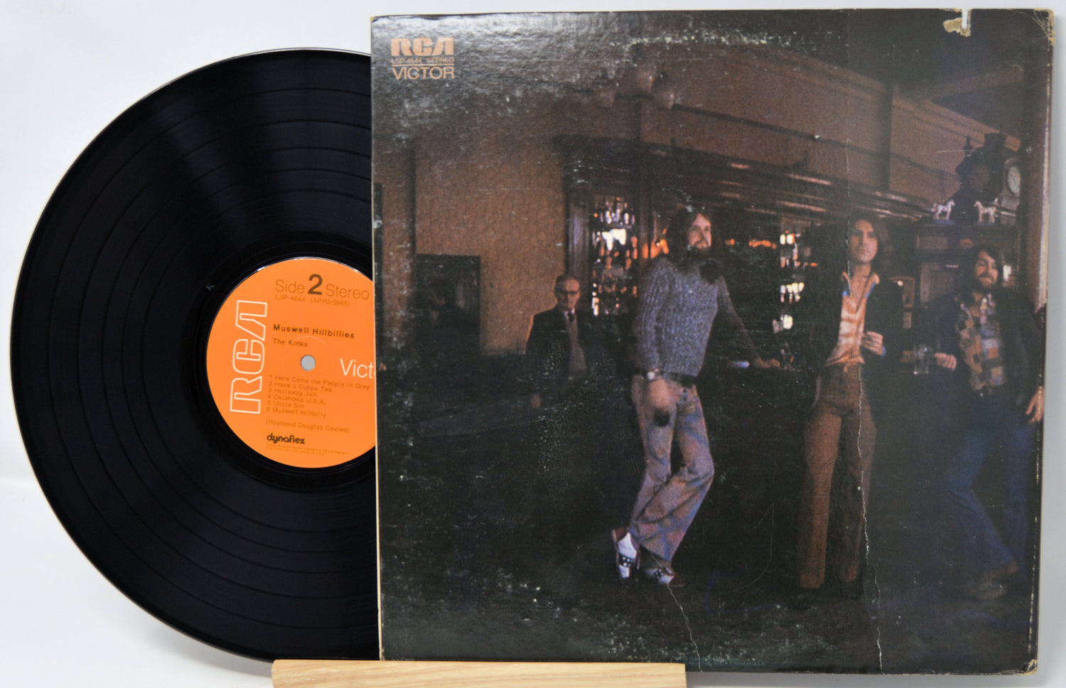 Vinyl record and cover with people in a bar setting