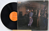 Vinyl record and cover with people in a bar setting