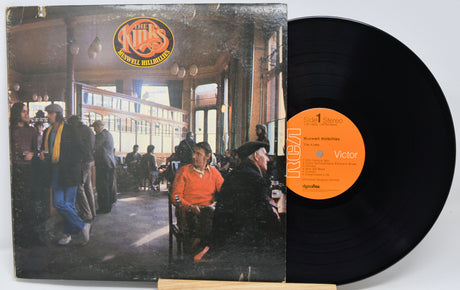 Vinyl record with cover showing a cafe scene and orange label