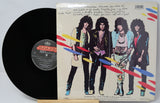Vinyl record with a colorful cover featuring four band members.