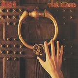 A vinyl record titled 'Kiss - Music from the Elder' with an image of a hand holding a large, gold-colored ring on a dark, wooden door.