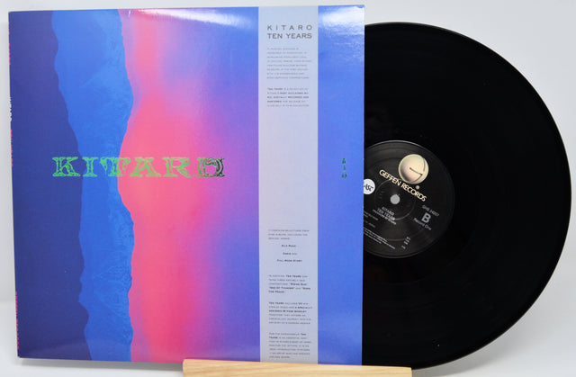 A vinyl record partially pulled from its sleeve, showing the album cover artwork and the black record itself on a light gray background.
