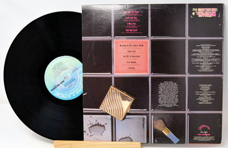 Vinyl record with a gold label and a black cover on a white background