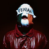 Person wearing a balaclava with 'FENIAN' text and a dark background