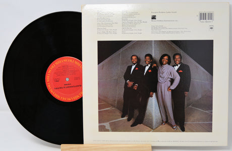 Vinyl record with cover featuring a group of people in formal attire.