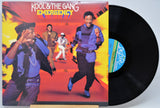 Vinyl record with 'Kool & The Gang Emergency' cover showing band members dancing.