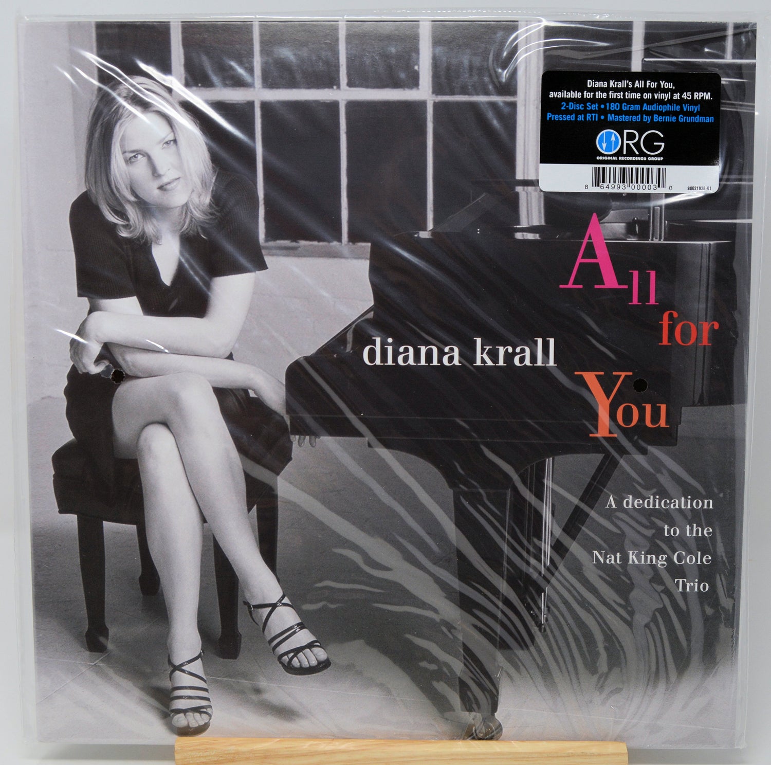 Diana Krall's 'All for You' vinyl record cover, sealed in plastic shrink wrap. The cover features a black-and-white photograph of Diana Krall sitting at a grand piano, with the title 'All for You' in white and coral-pink text.