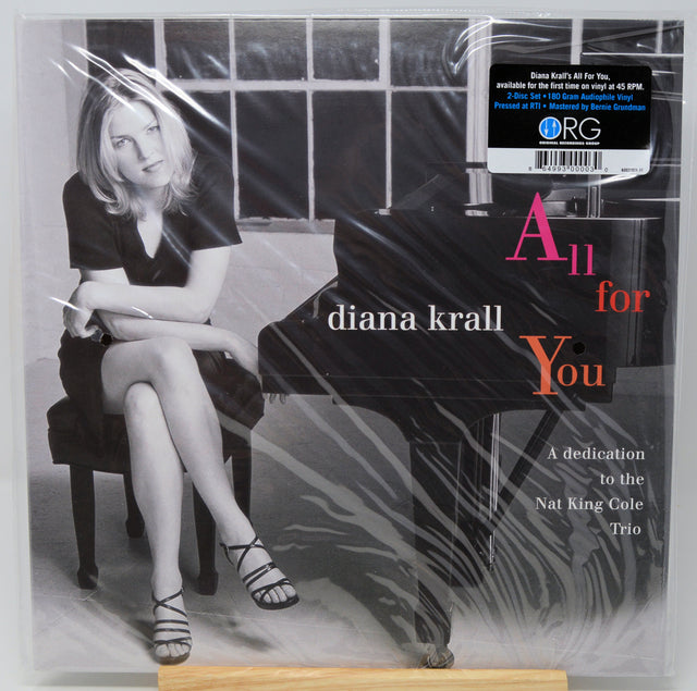 Diana Krall's 'All for You' vinyl record cover, sealed in plastic shrink wrap. The cover features a black-and-white photograph of Diana Krall sitting at a grand piano, with the title 'All for You' in white and coral-pink text.