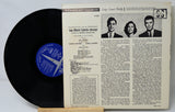 Vinyl record with a detailed cover featuring text and images of people.