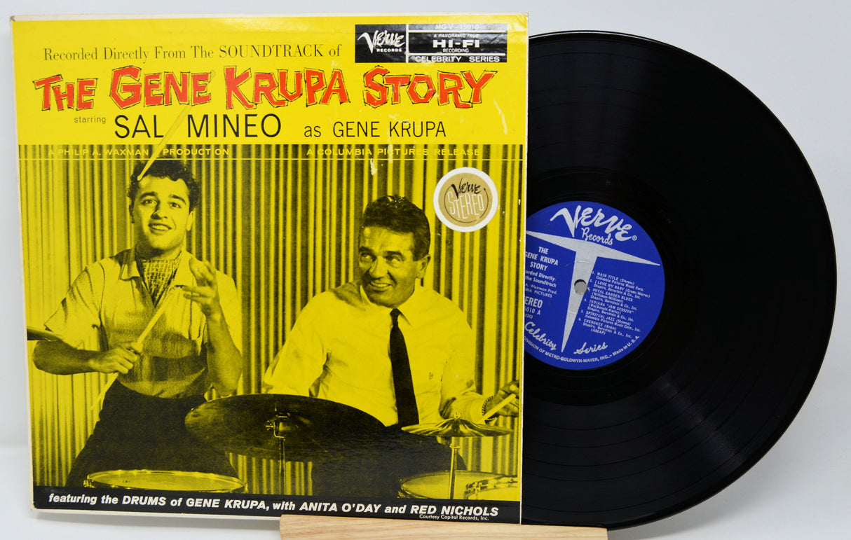 Vinyl record and cover titled 'The Gene Krupa Story' with a yellow background and black vinyl disc.